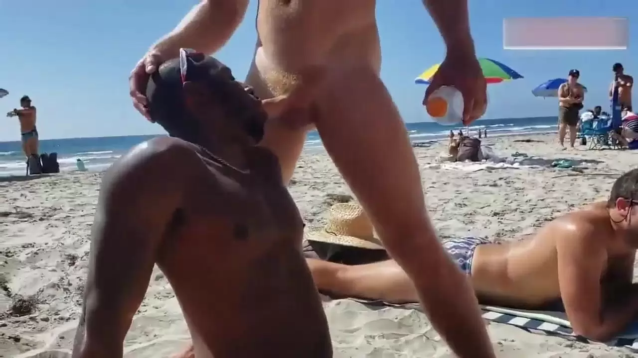 Black and white gay on a public beach photo